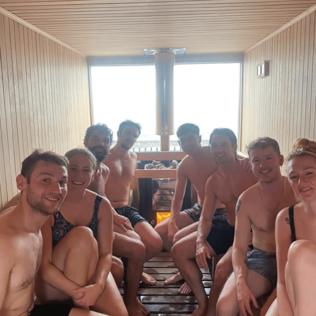 Friends enjoying a group sauna session with real fire